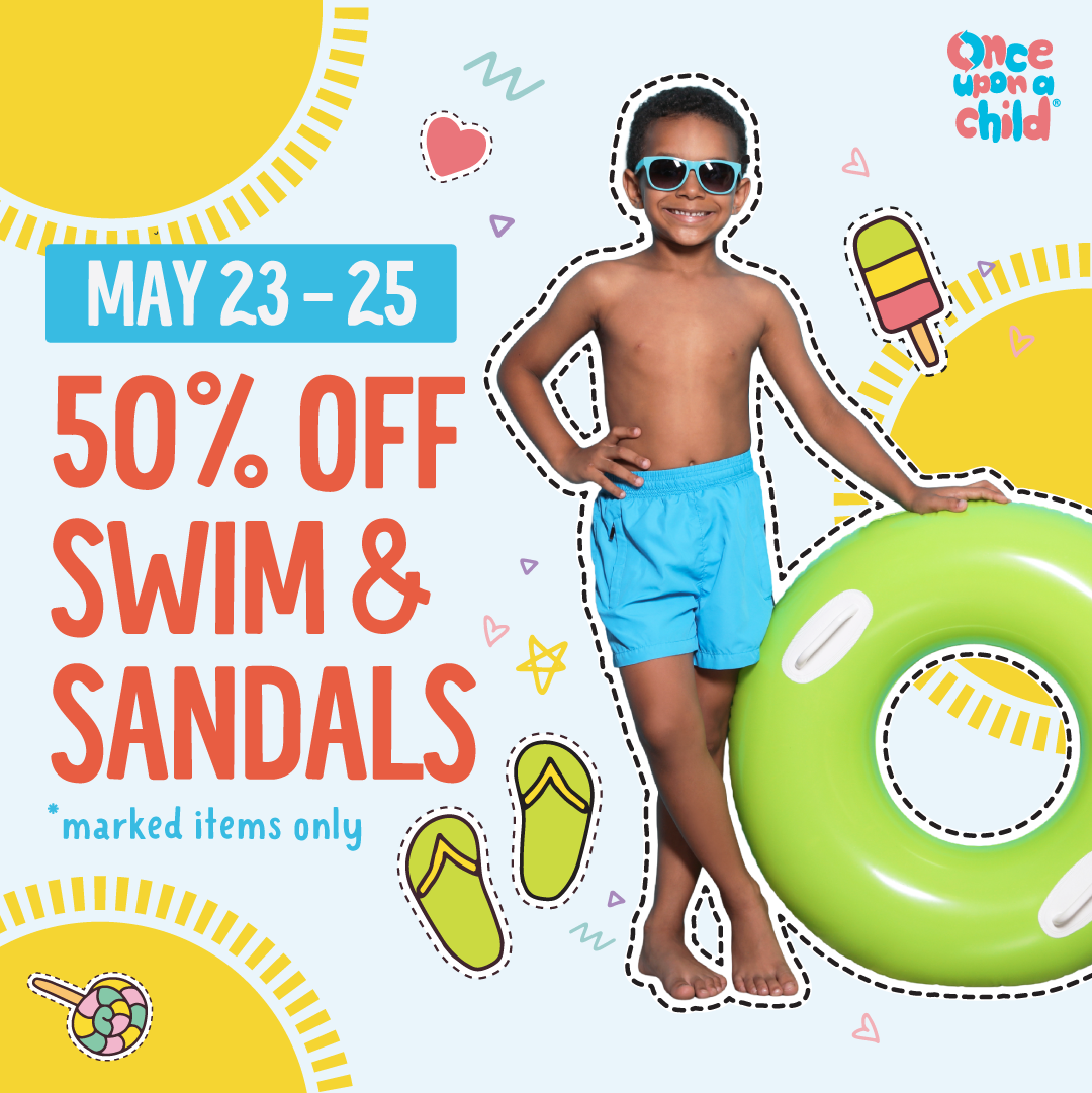 Boy wearing swimwear with pool toy